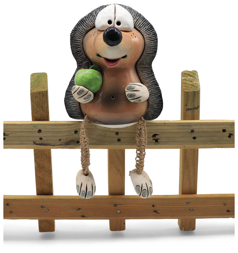 Fence-sitting hedgehog with apple
