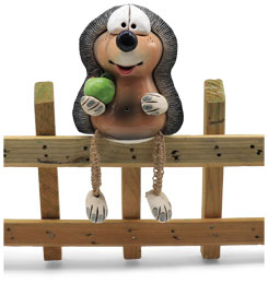 Fence-sitting hedgehog with apple